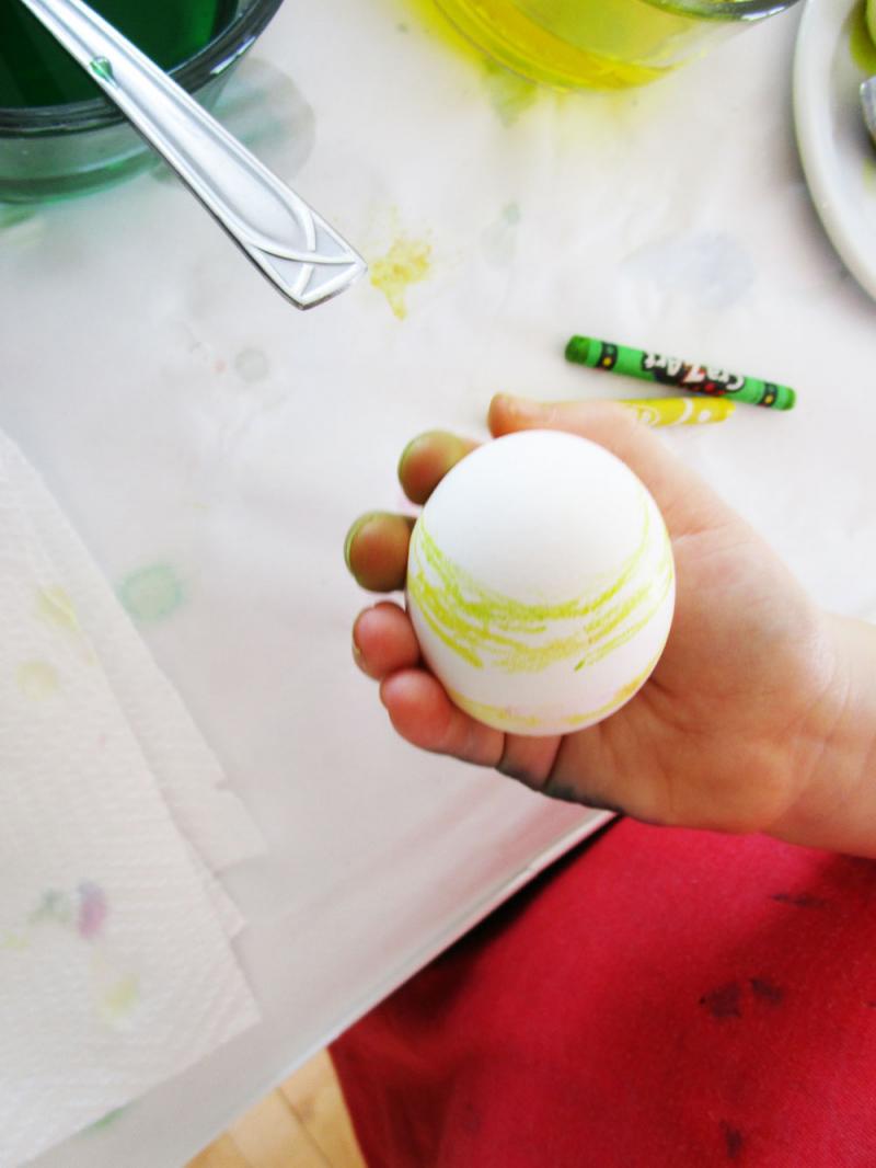 A hard boiled egg with crayon decorations.