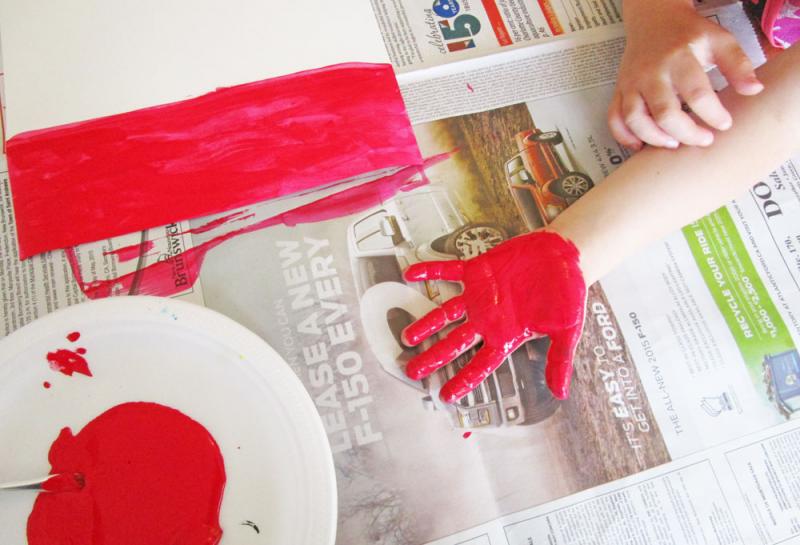 Paint your child's hand red. 