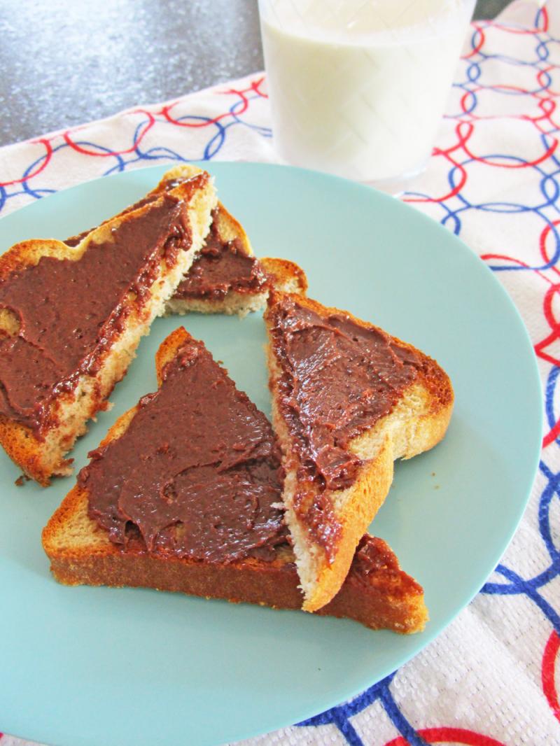 Chocolate butter on toast with a glass of milk.