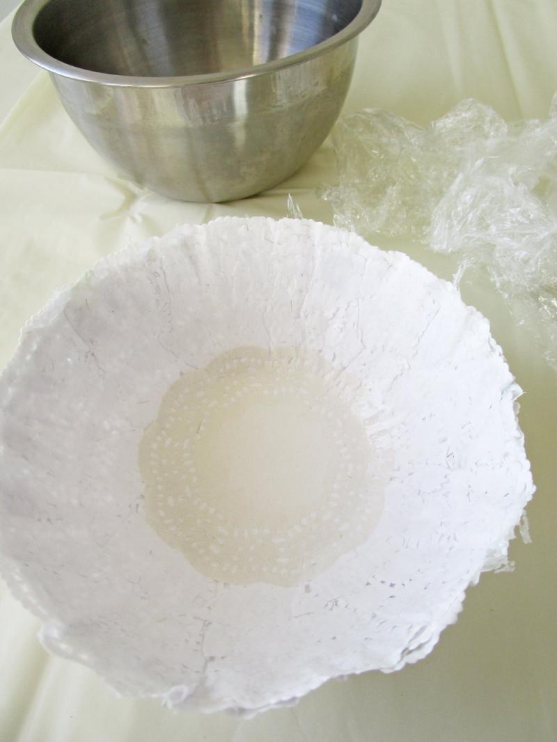 When dry, remove the hardened doilies from the bowl and remove the plastic wrap from the doilies. 