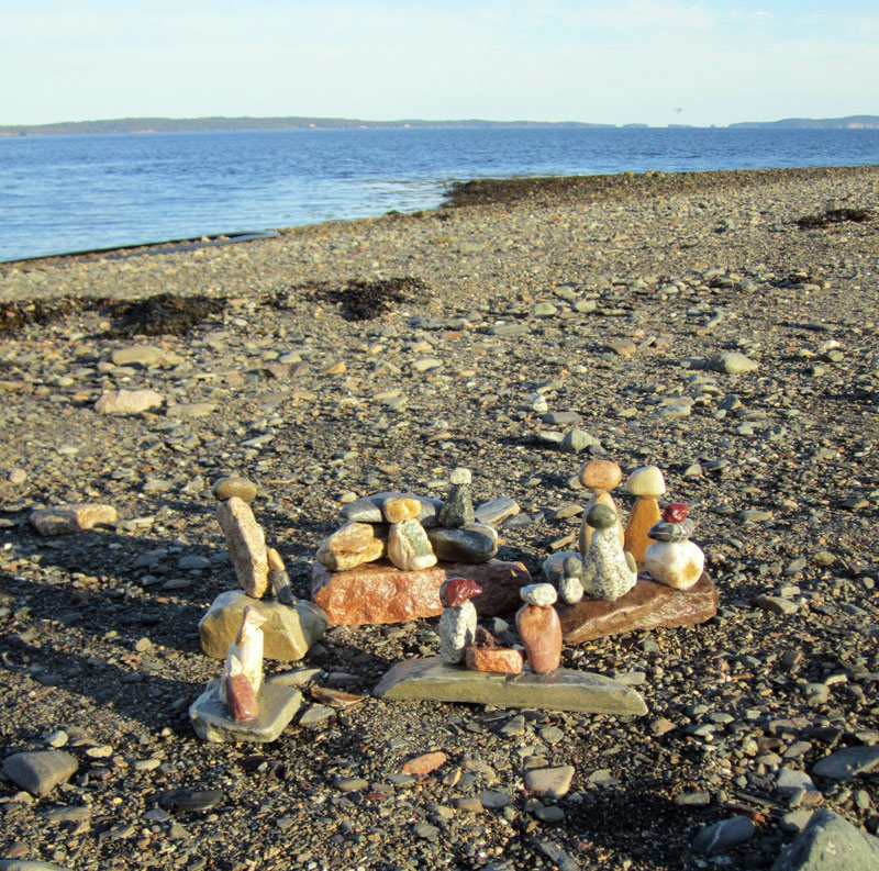 Kids can make sculptures with stones at the beach.