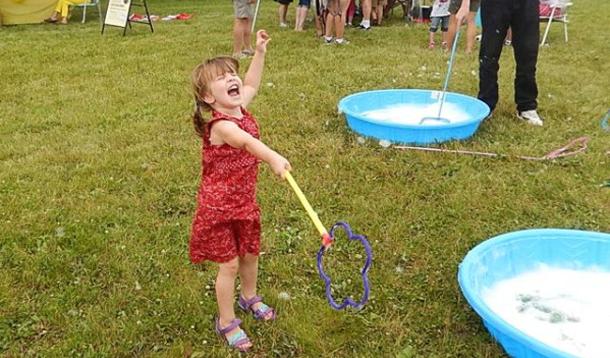 Joe's daughter rocking out with giant bubble wands