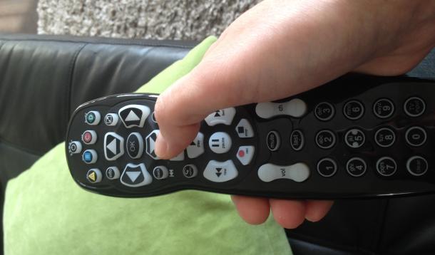 Woman's hand holding remote control