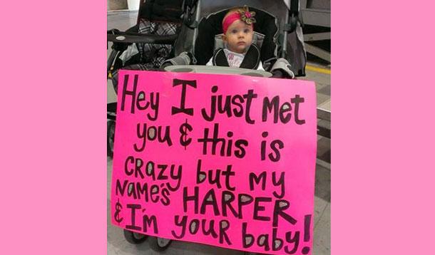 baby with welcome home sign