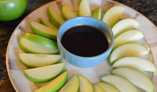 Granny Smith apple slices with a bowl of caramel sauce