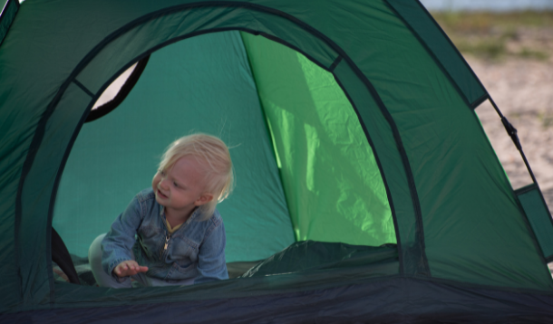 Toddler in a green tent