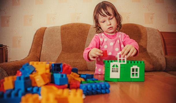 girl playing with lego