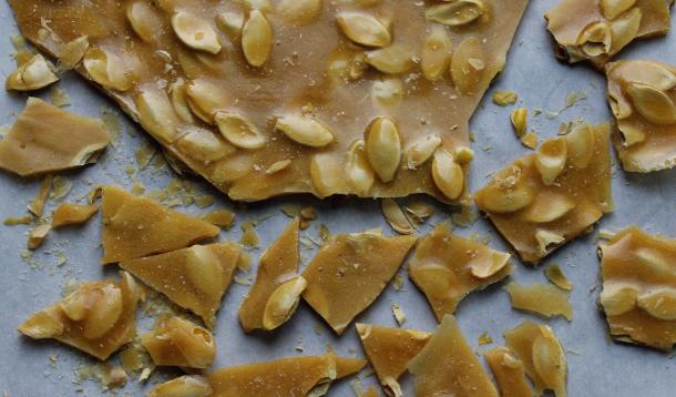 After carving the pumpkin, make some Roasted Pumpkin Seed Brittle recipe this Halloween! Not only is this sweet treat delicious on its own, you can use it as a pretty fall garnish for cheesecake or panna cotta. All you need is a candy thermometer! | YMCFood | YummyMummyClub.ca