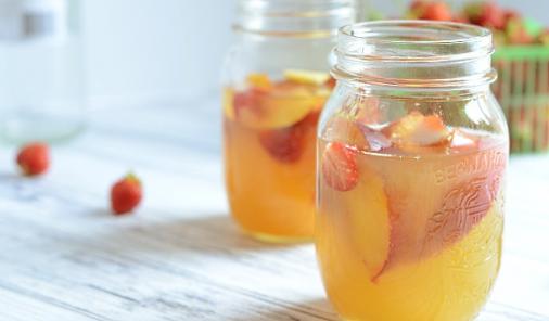 This white wine sangria is sweetened with peach nectar and ripe strawberries to make a perfect summer drink!