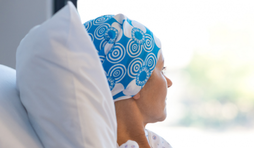 Woman with headwrap looking out window