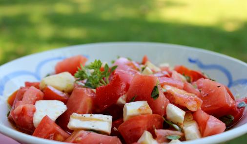 Ripe tomatoes and brie drizzled with hot olive oil and dressed with basil make for a delicious summery salad