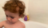 toddler playing in bathtub