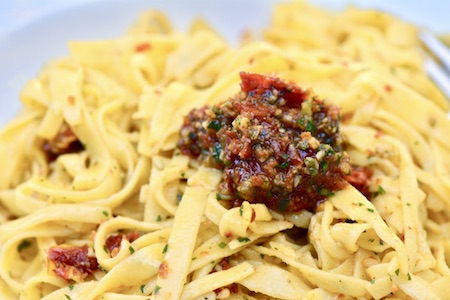 This 20 minute no-cook sundried tomato pesto is a riff on a traditional pesto.  Made with a base of sundried tomatoes and parsley, it is super easy to throw together and jam packed with flavour. | YMCfood | YummyMummyClub.ca