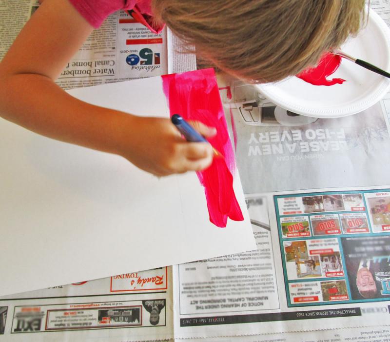 Paint the edges of the paper to look like a Canadian flag. 