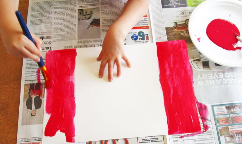 Paint the edges of the paper to make it look like a Canadian flag.