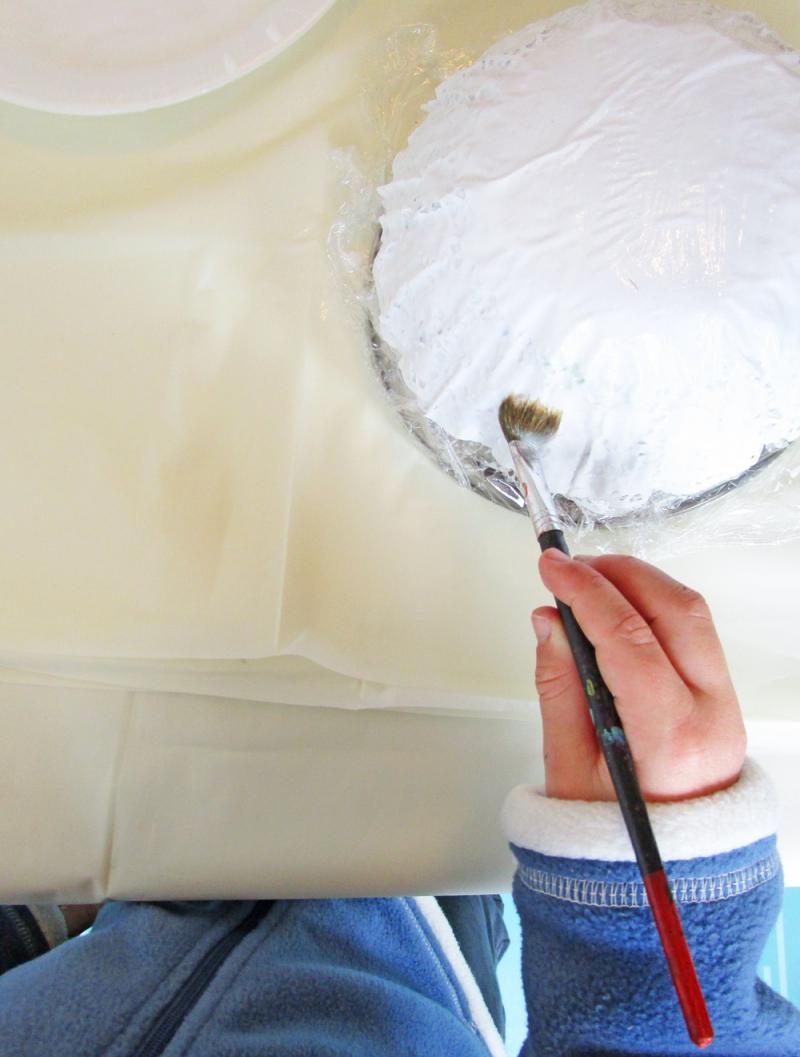 Continue to layer paper doilies on the bowl. 