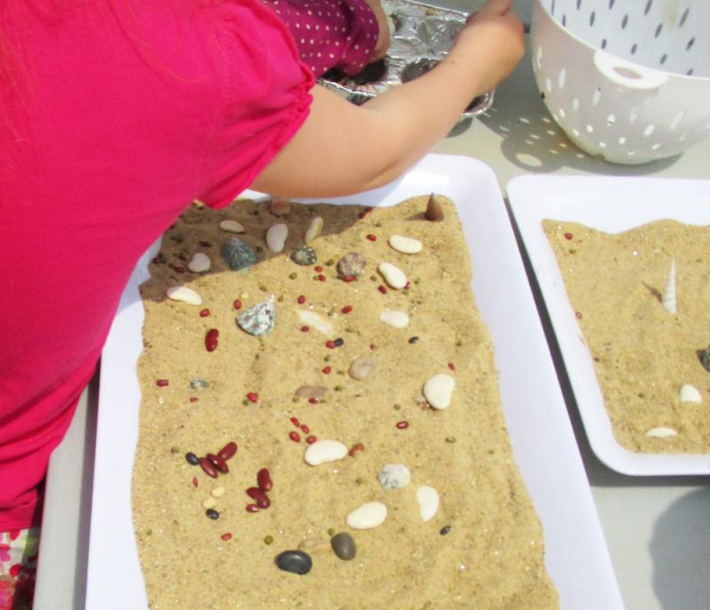 Kids can make temporary mosaics with sand.